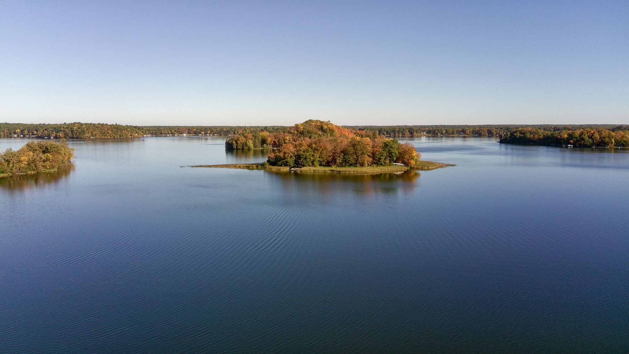 Drone photo of wooded islands on a calm lake